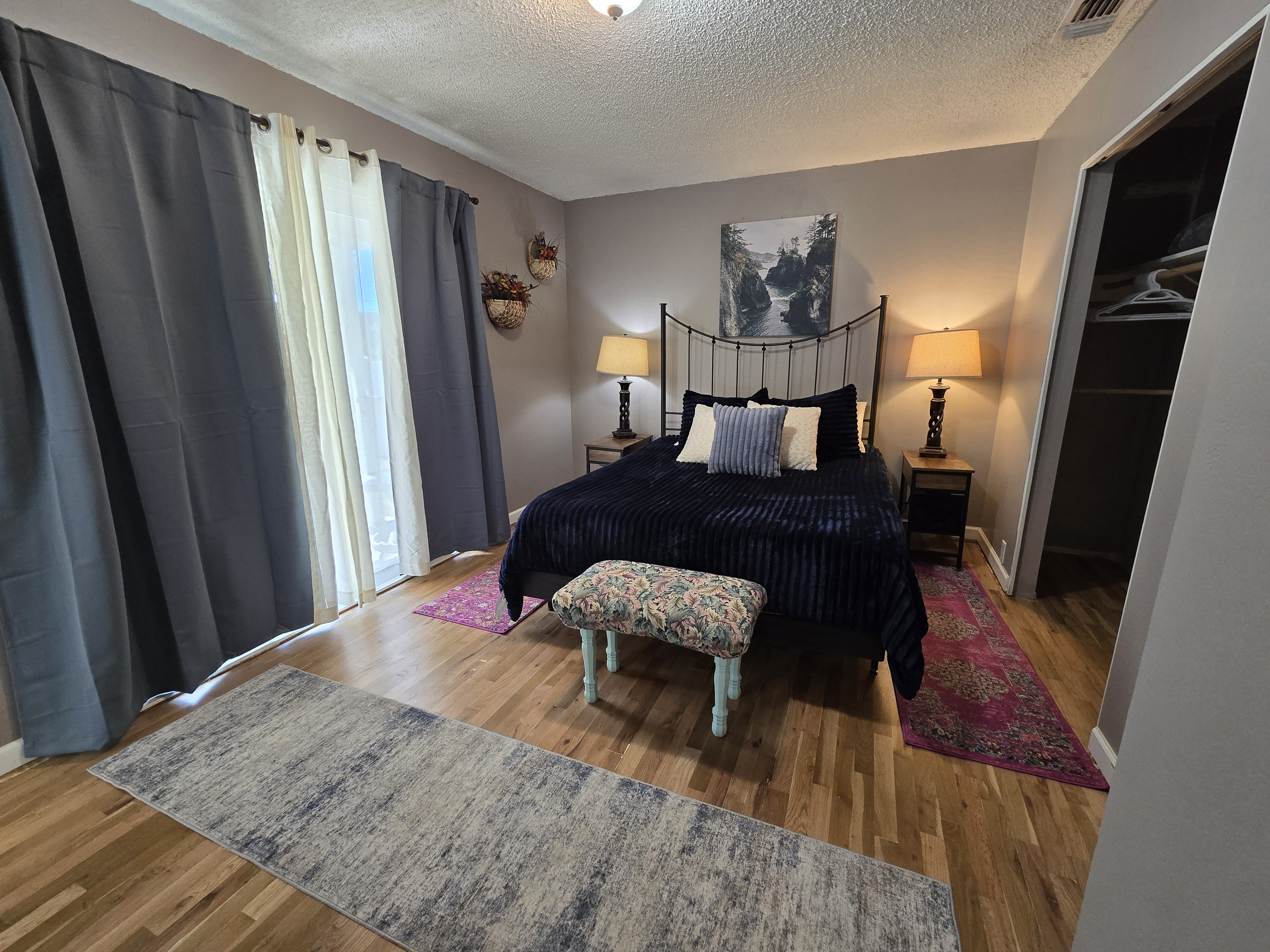 Cozy, light-filled bedroom with hardwood floors and stylish decor