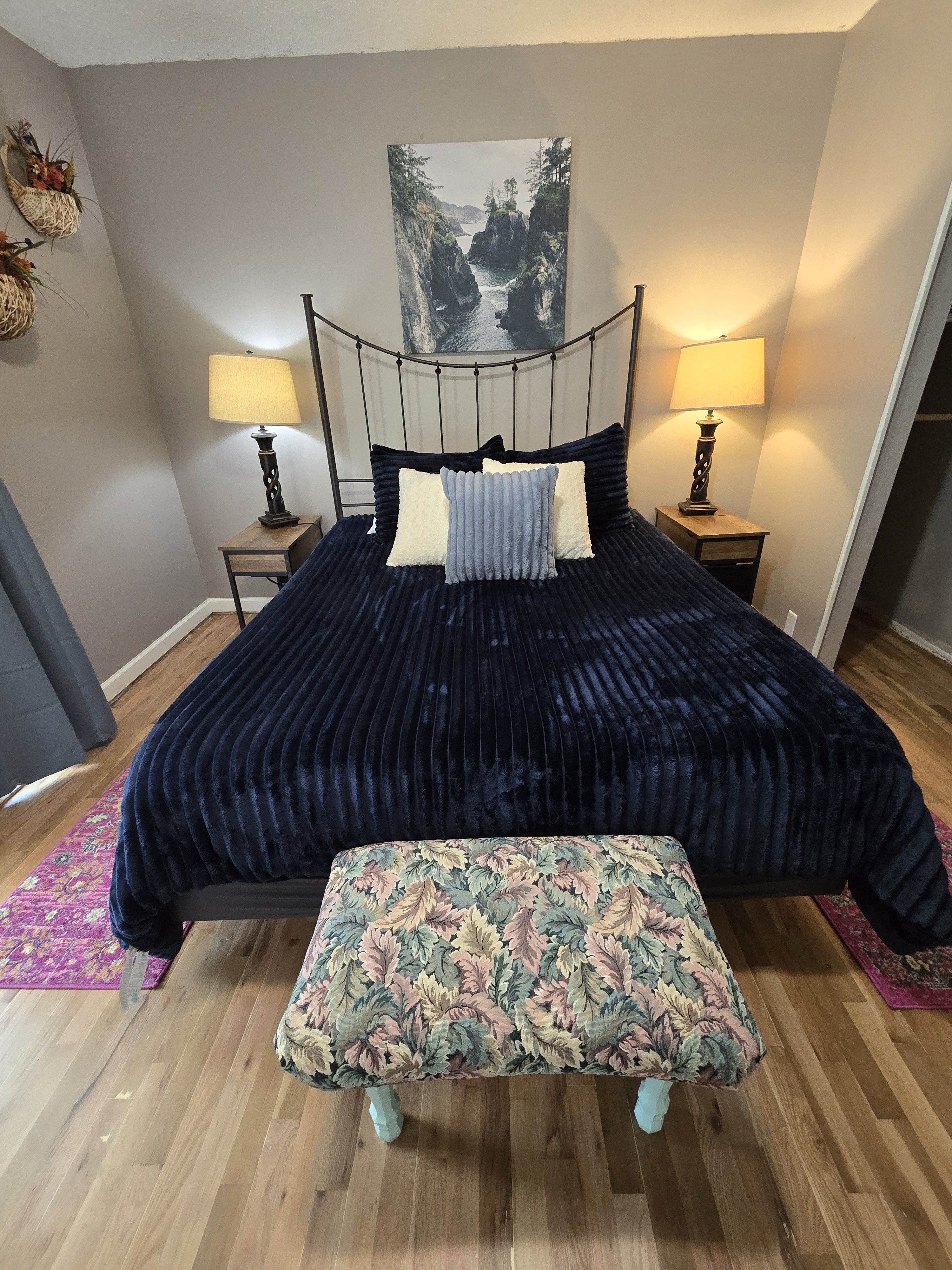 Cozy bedroom with elegant iron bed, warm lighting, and charming accents