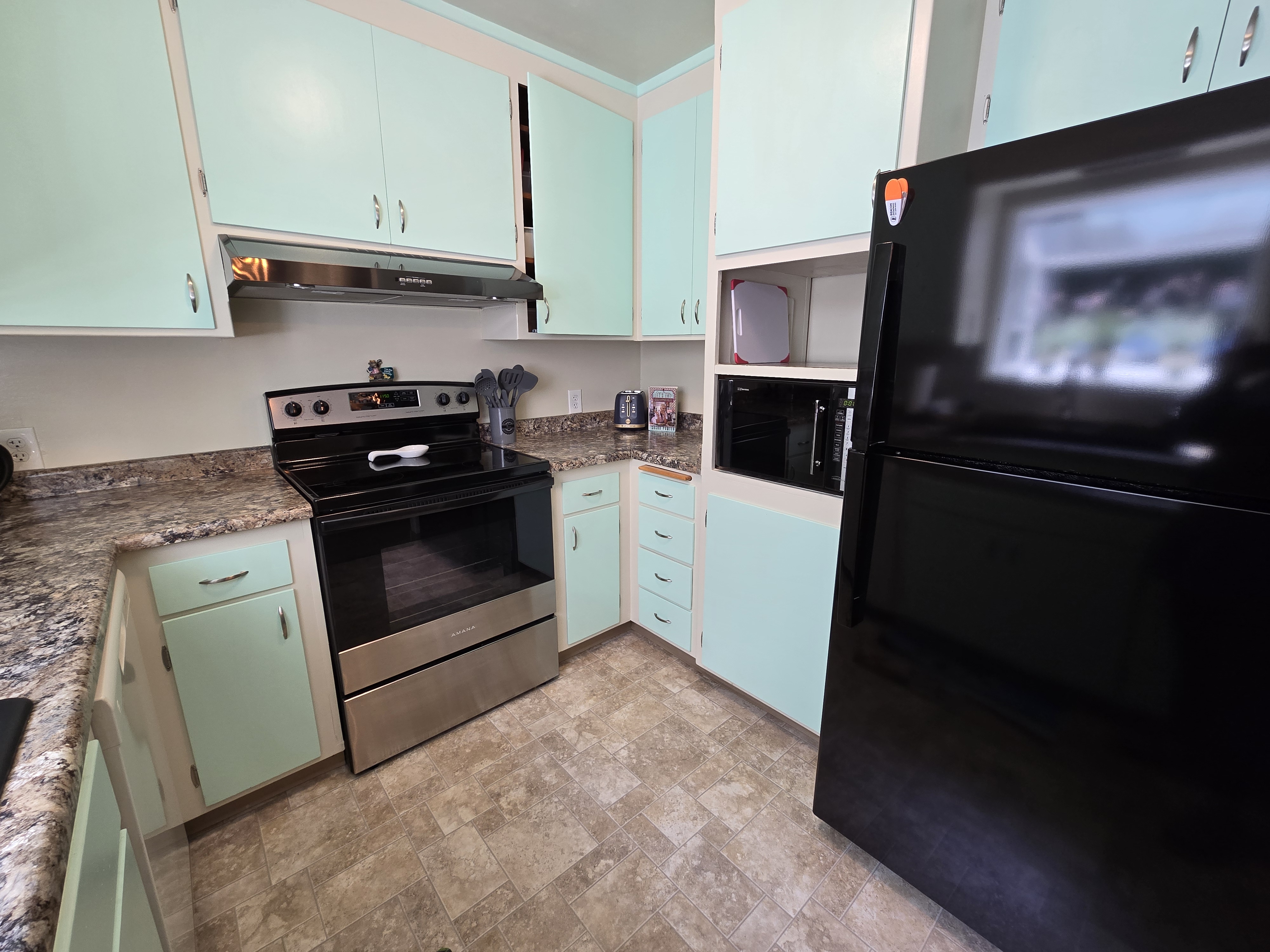 Bright retro-style kitchen with ample counters and full-size appliances
