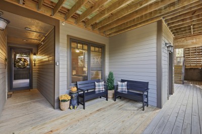 Inviting covered porch with cozy seating and warm rustic charm