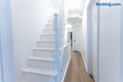 Bright hallway with staircase and stylish wood-look flooring