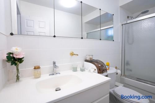 Bright modern bathroom with mirrored vanity and tub-shower combo