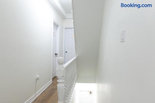 Bright upper hallway with clean finishes and classic stair detailing