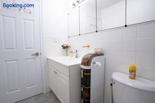 Bright, spotless bathroom with mirrored storage and roomy vanity