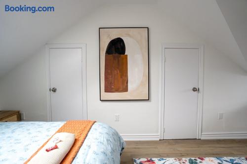 Bright minimalist bedroom with airy vaulted ceilings and modern art
