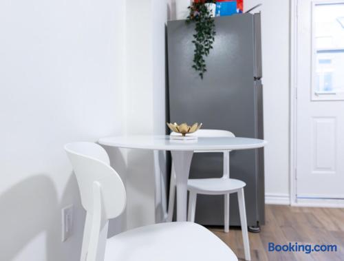 Bright modern dining nook with table seating and full-size fridge
