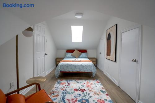 Cozy skylit attic bedroom with floral accents and clean modern style