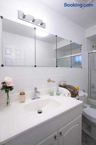 Bright, spotless bathroom with large mirror and glass-enclosed shower