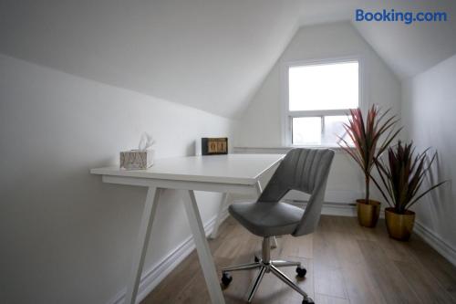 Bright loft workspace with modern desk, natural light, and stylish plants