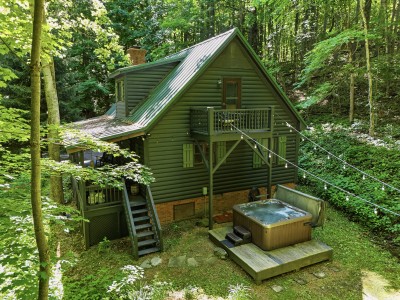 Secluded forest cabin with private hot tub, balcony, and peaceful woodland views