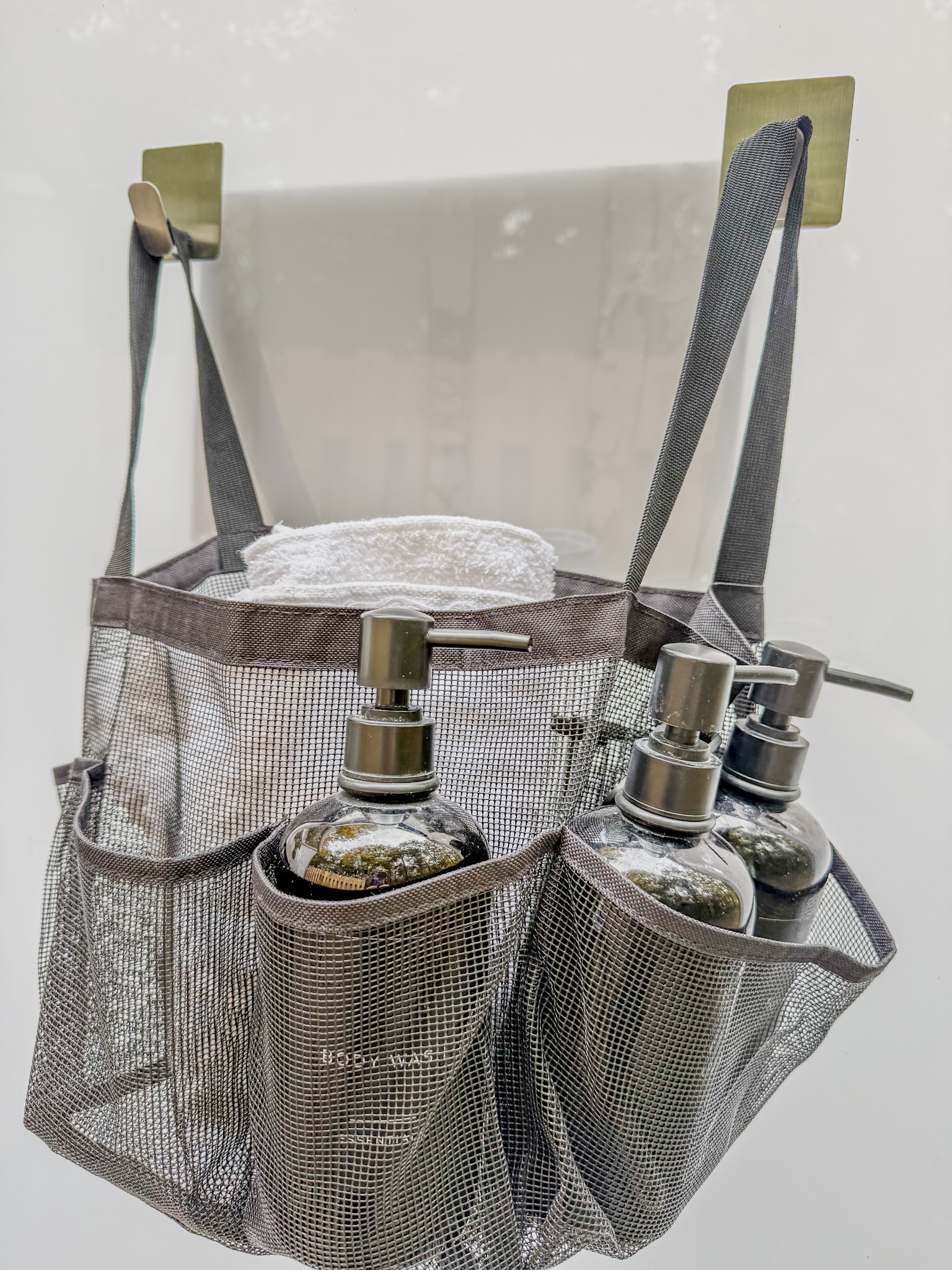 Organized bathroom caddy with towels and premium toiletry dispensers