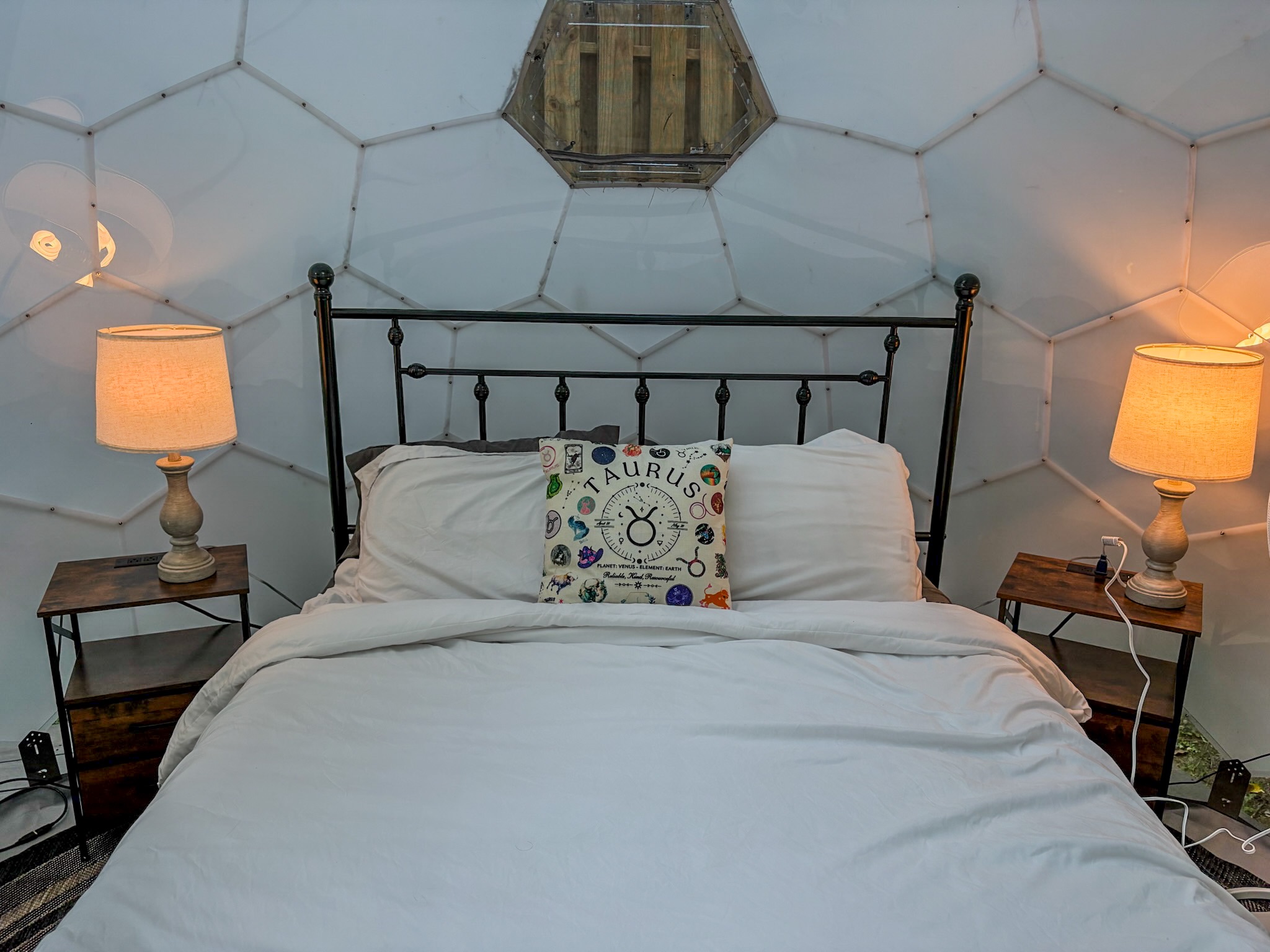 Cozy dome bedroom with warm lighting and a unique glamping feel
