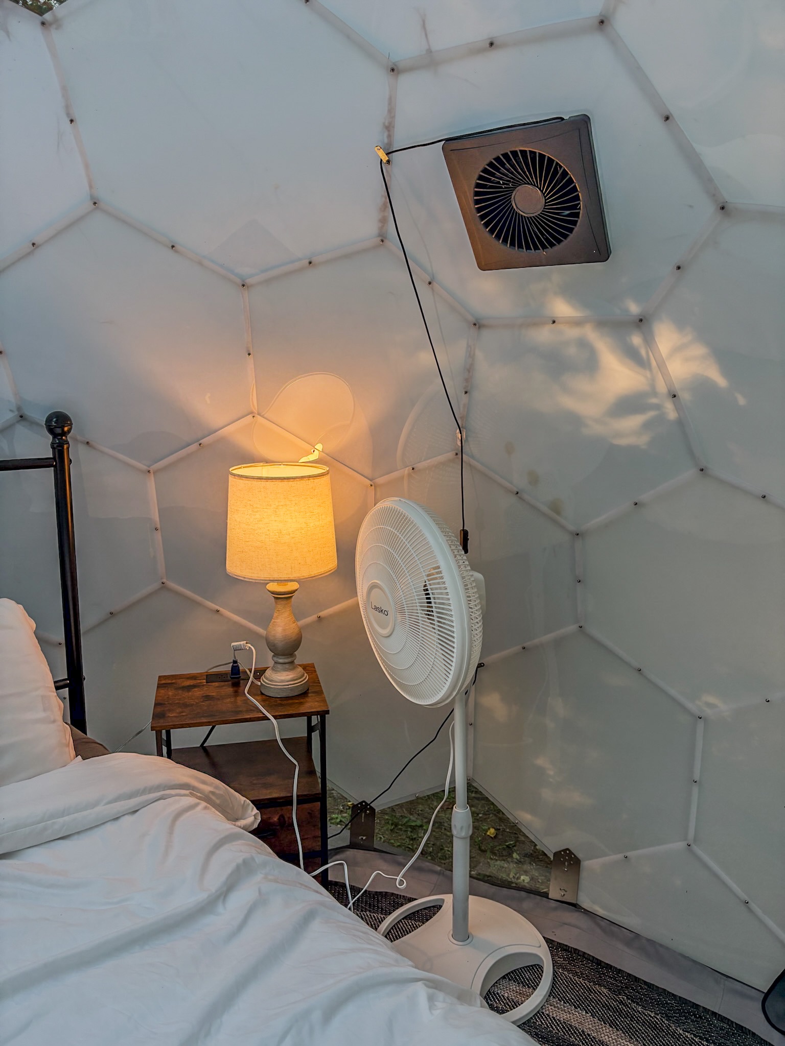Cozy dome bedroom with warm lighting, airflow, and unique glamping charm