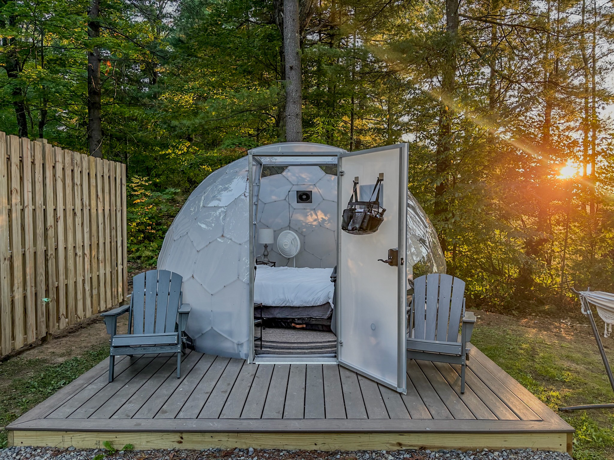 Forest glamping dome with private deck, cozy bed, and sunset views