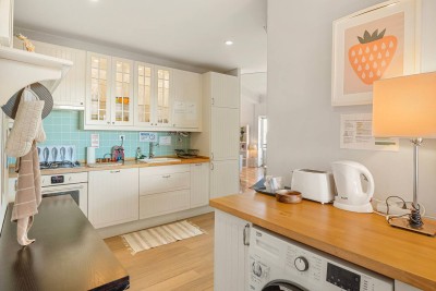 Fully equipped kitchen with dishwasher, fridge, freezer, oven, microwave, coffee machine, toaster, kettle and clothes washing/dryer machine.