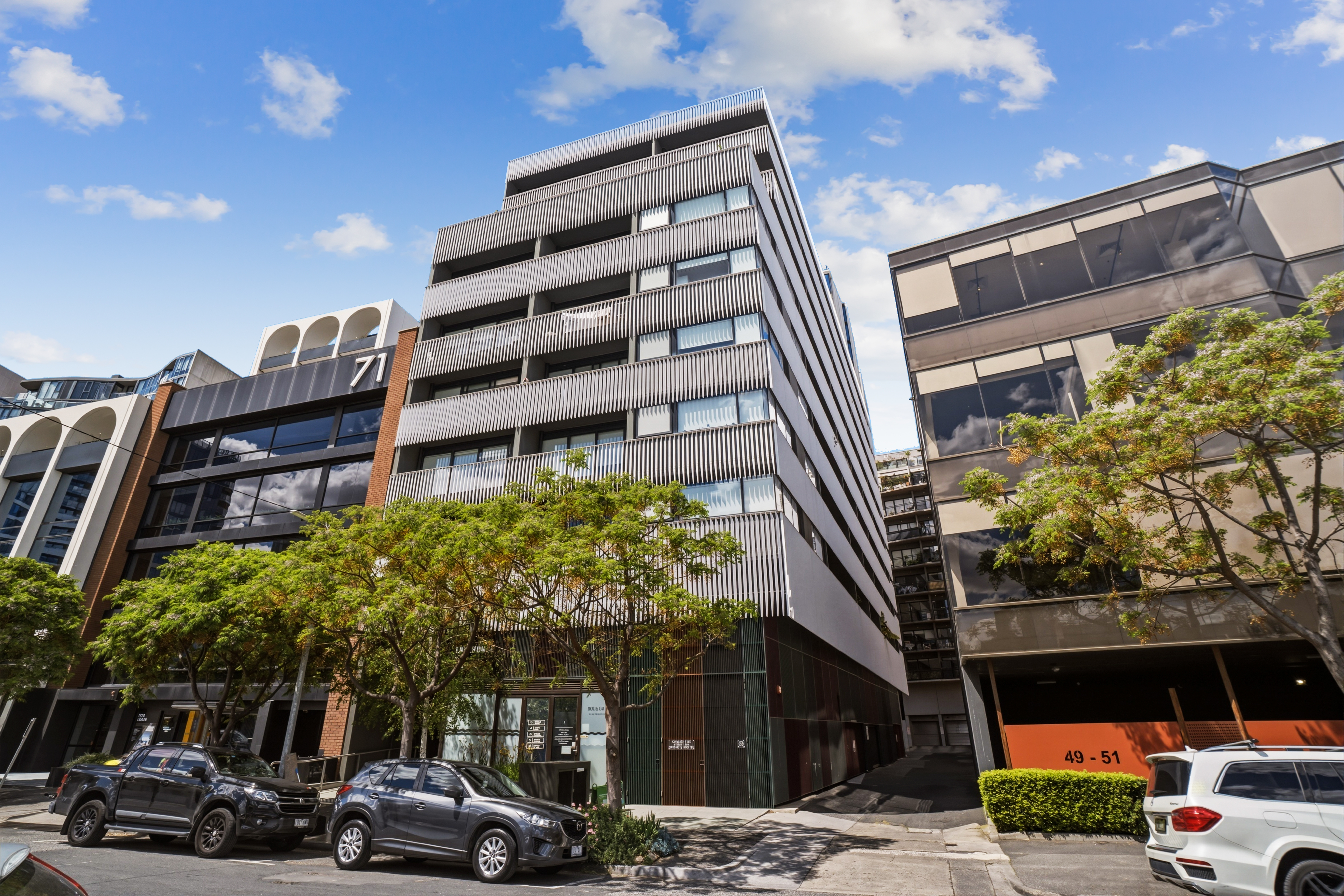 Modern city stay in a sleek, tree-lined apartment building