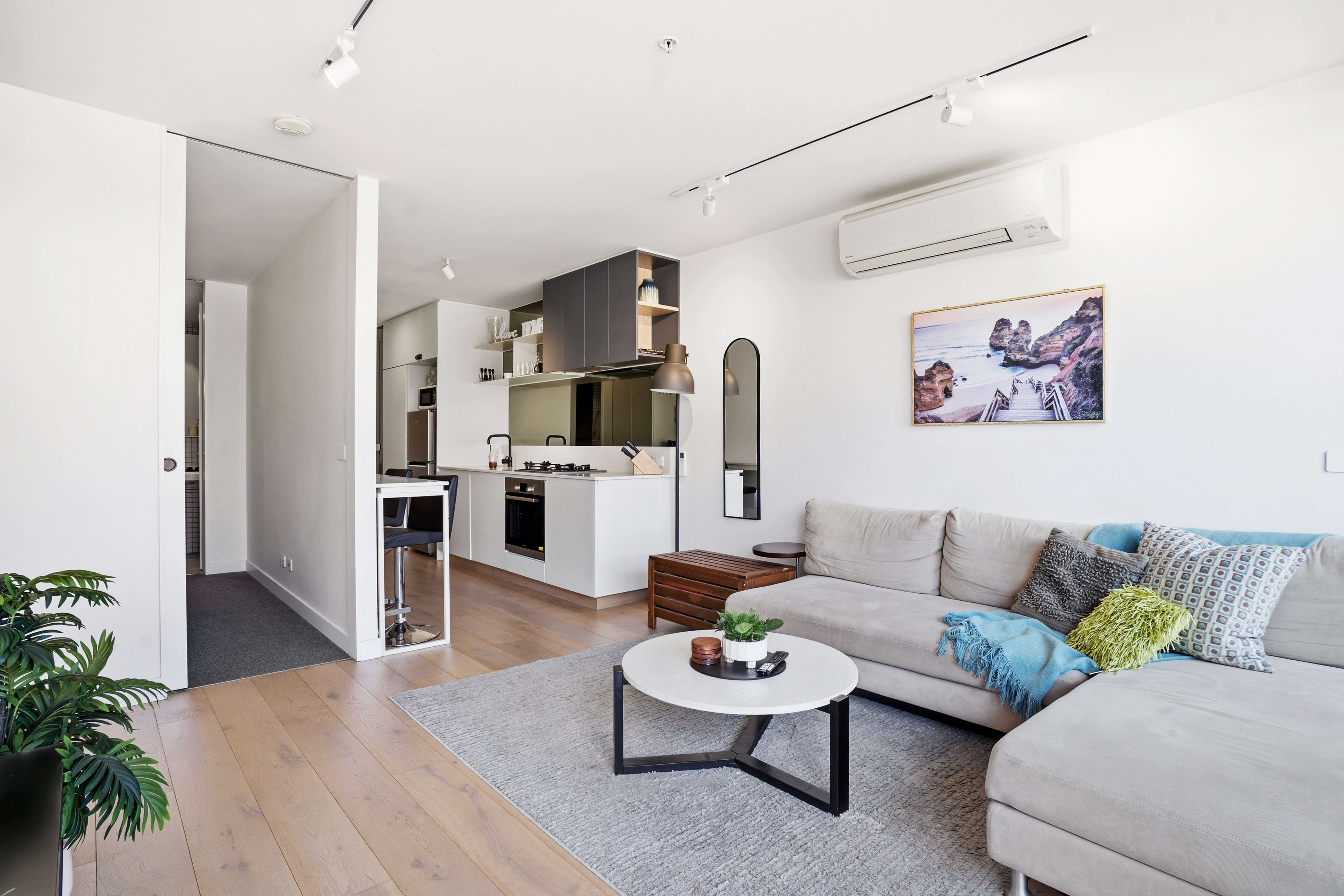 Bright modern lounge with sleek kitchen and cozy sectional seating