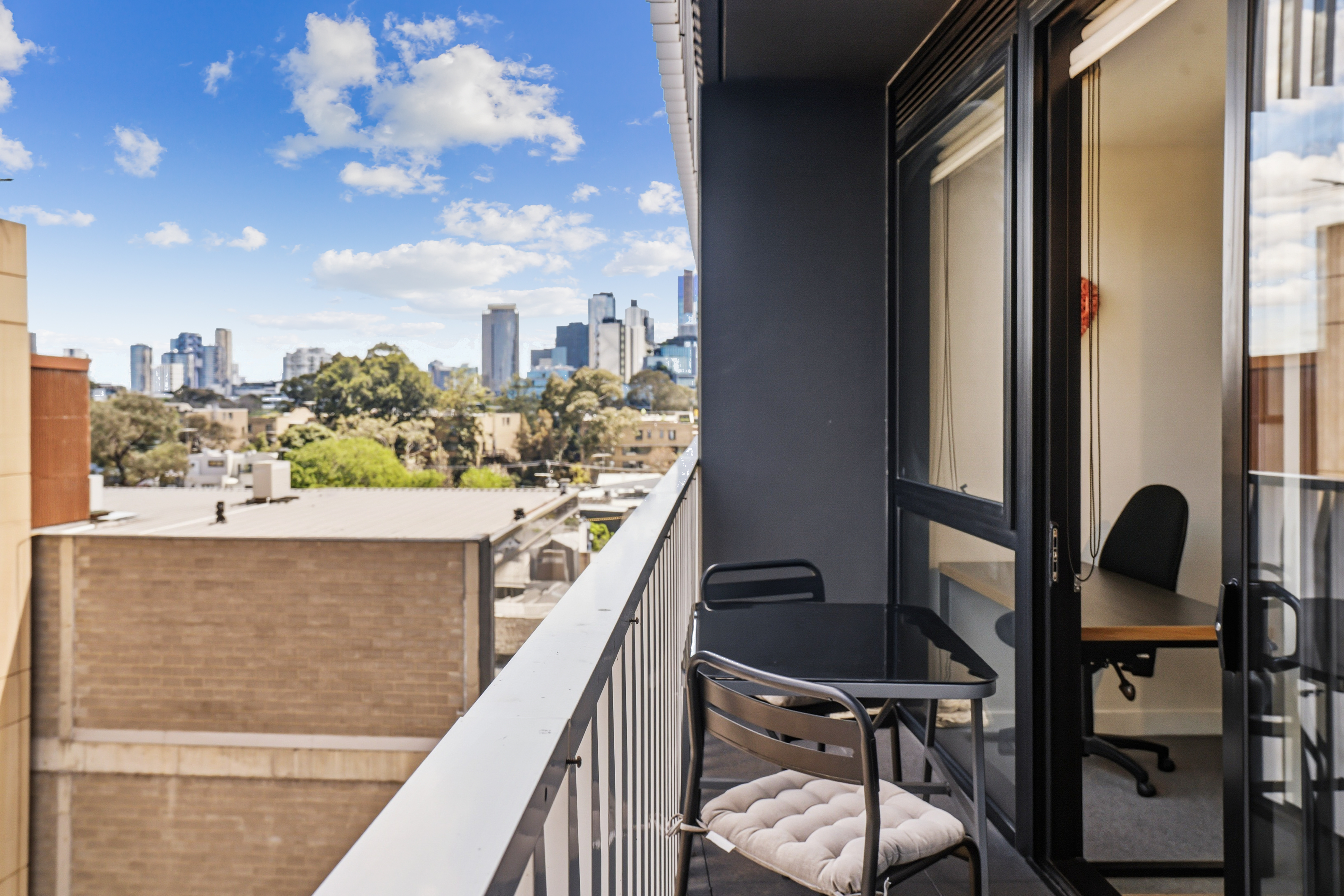 Private balcony with seating and sweeping city skyline views