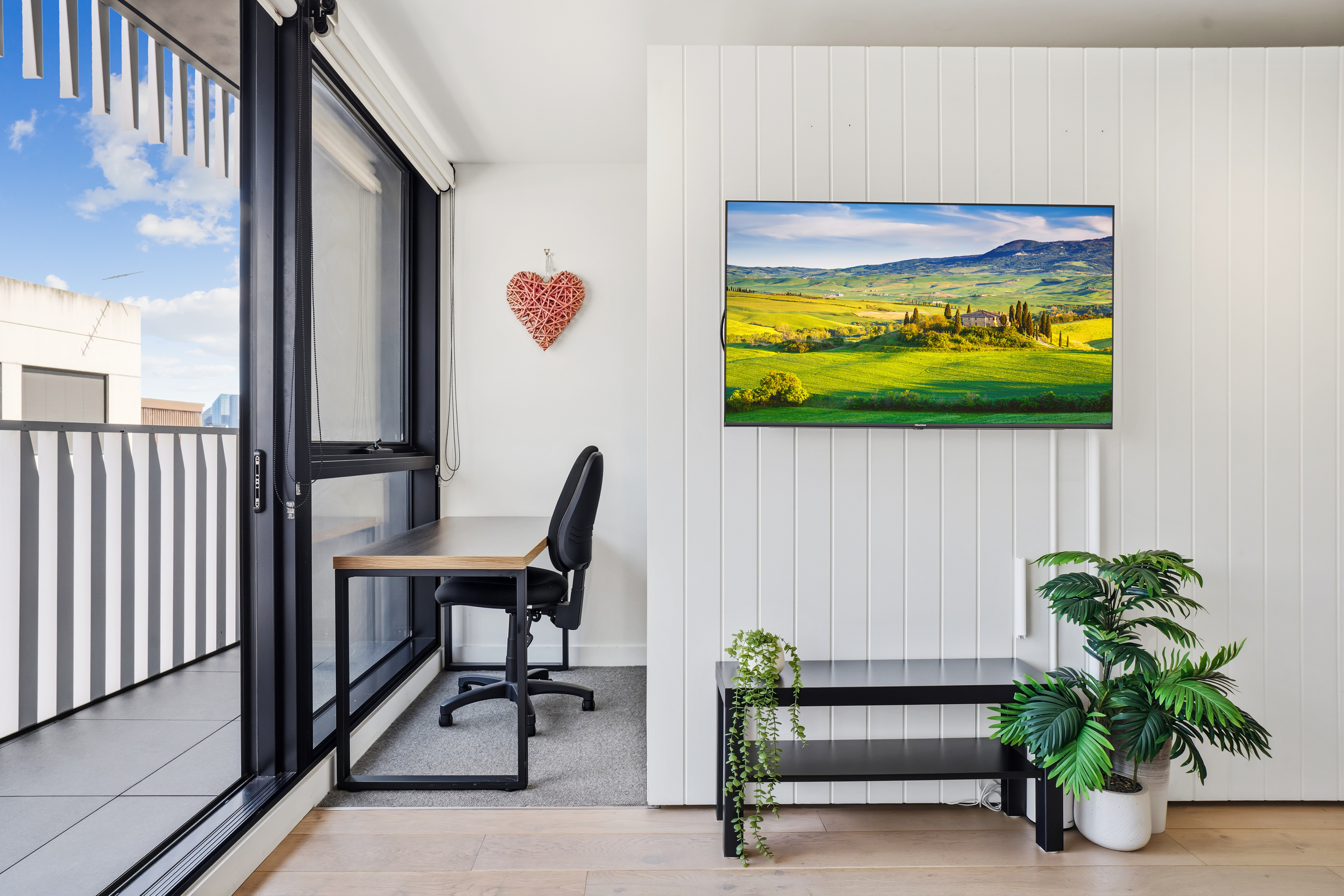 Bright modern stay with balcony, TV, and sunny work nook