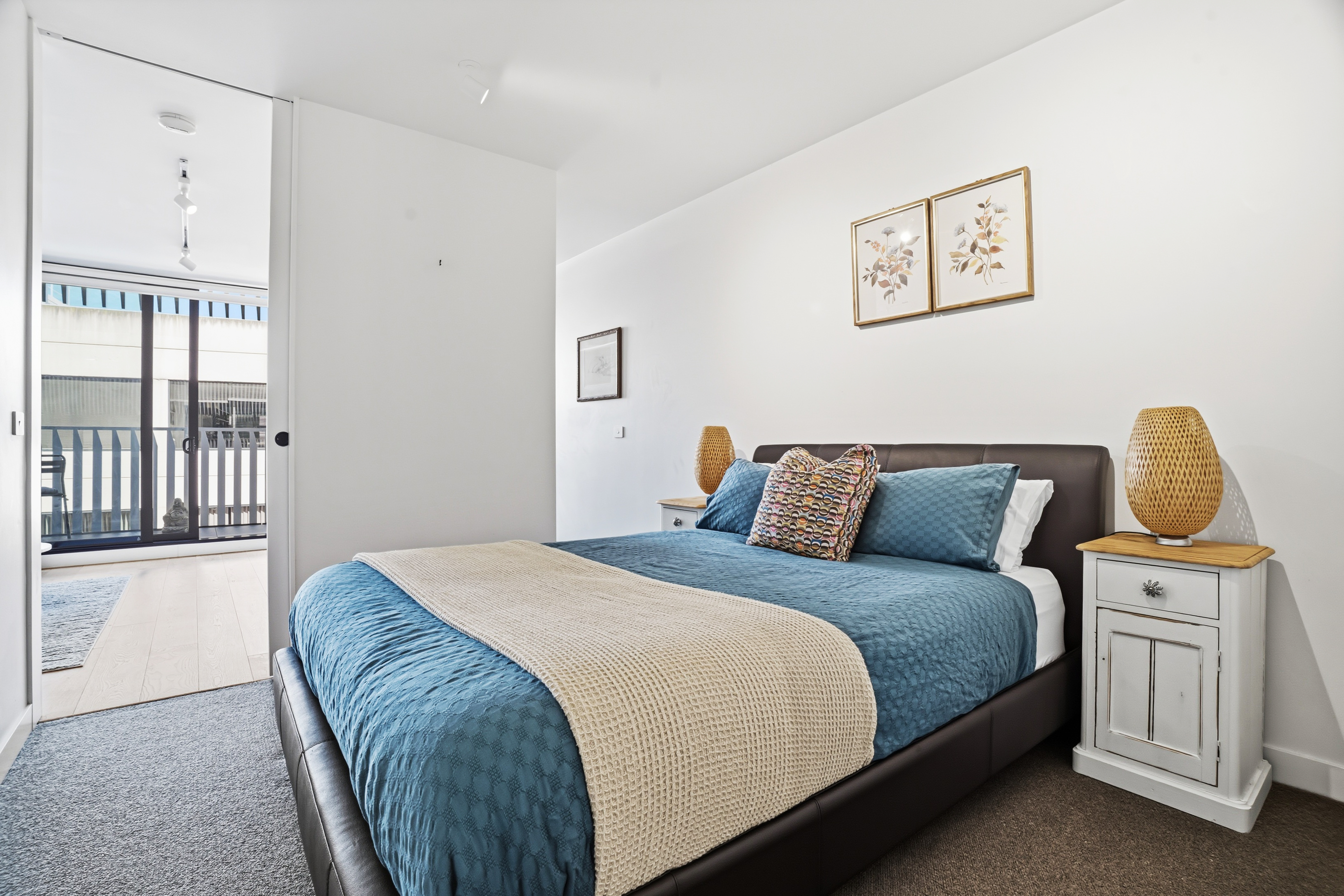Bright, cozy bedroom with balcony access and stylish modern touches