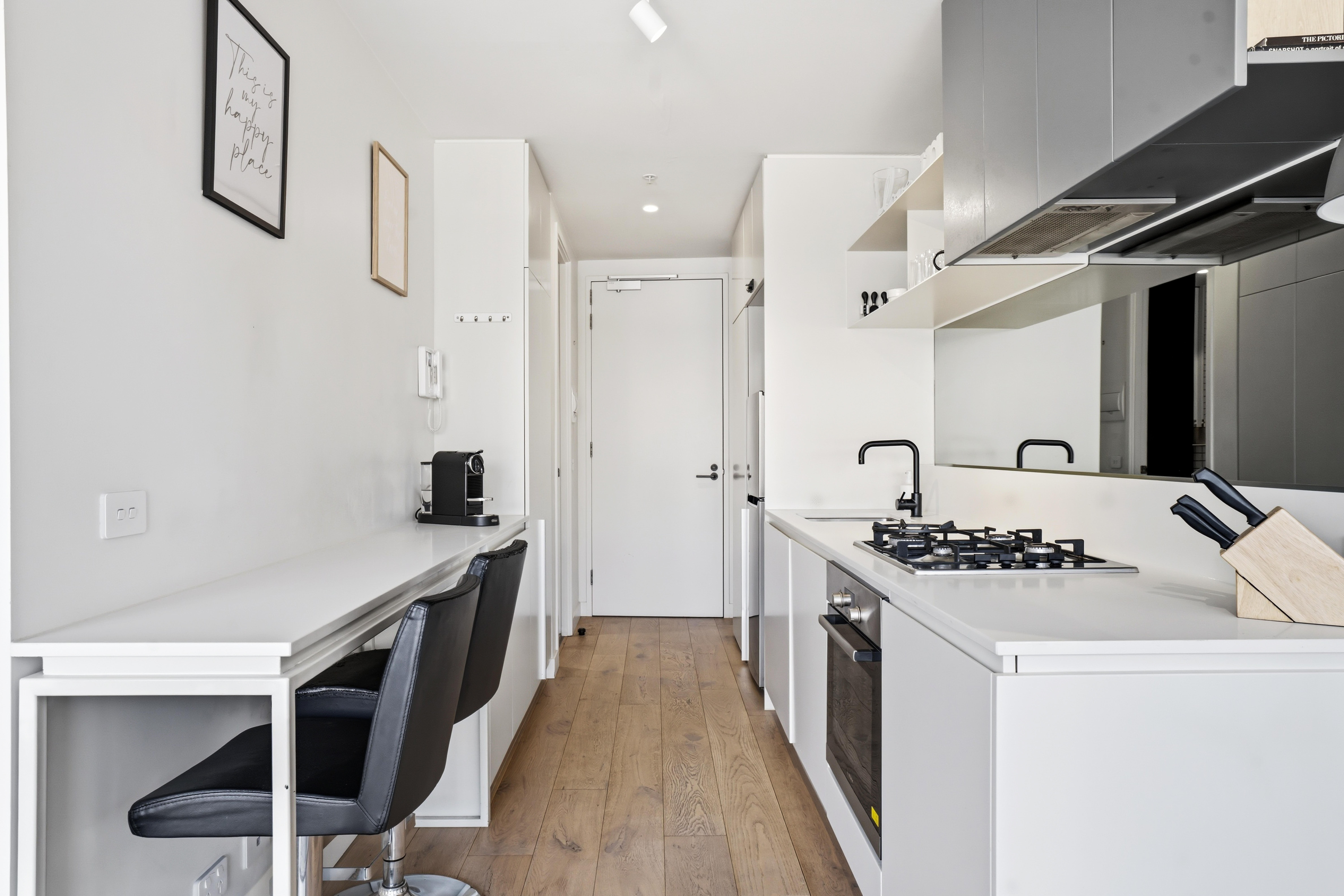 Bright modern galley kitchen with breakfast bar and sleek finishes