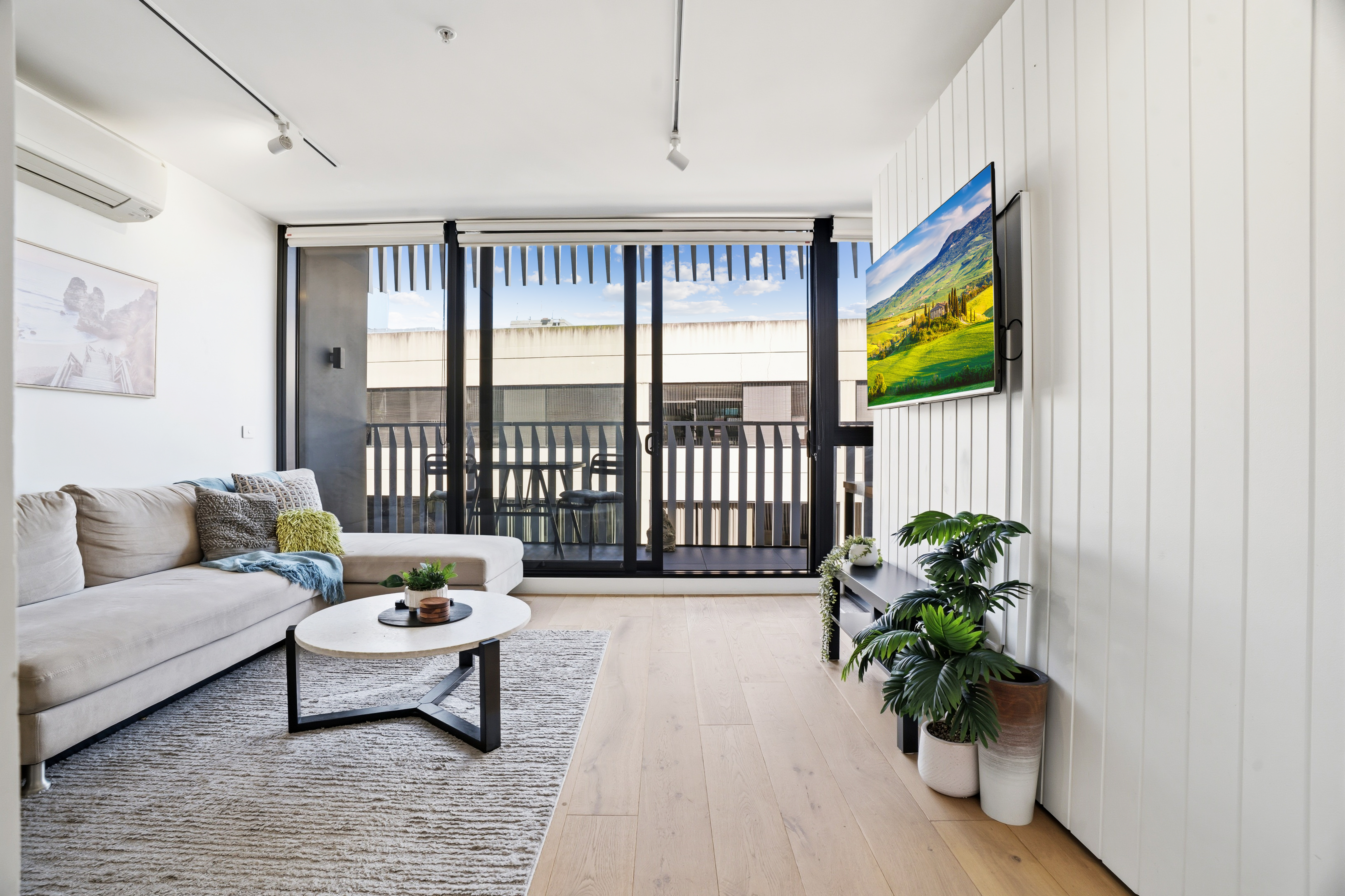 Bright modern lounge with balcony access and abundant natural light