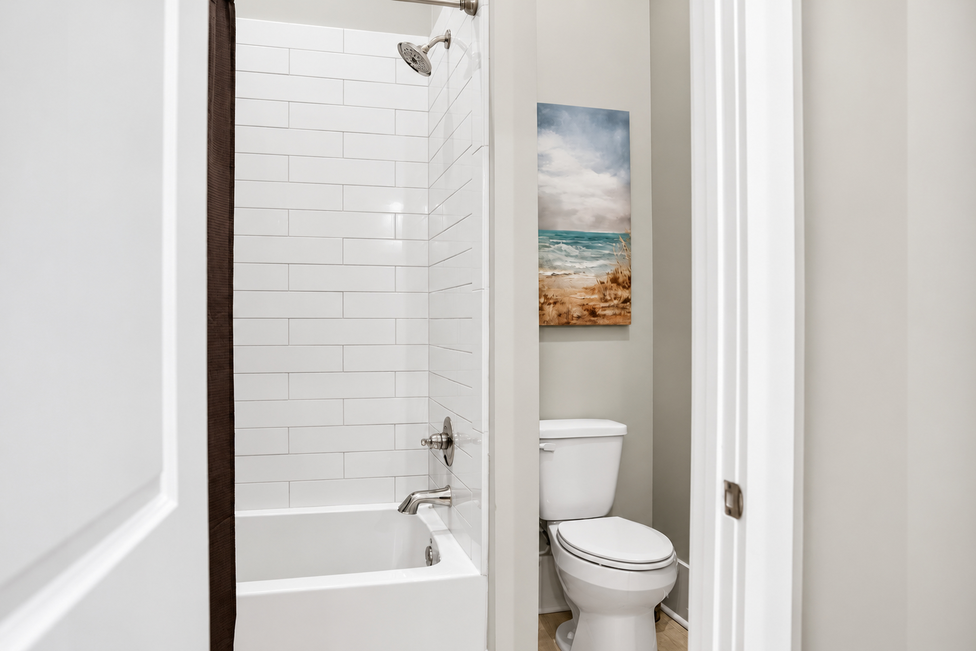 Bright modern bathroom with subway tile shower and fresh coastal decor