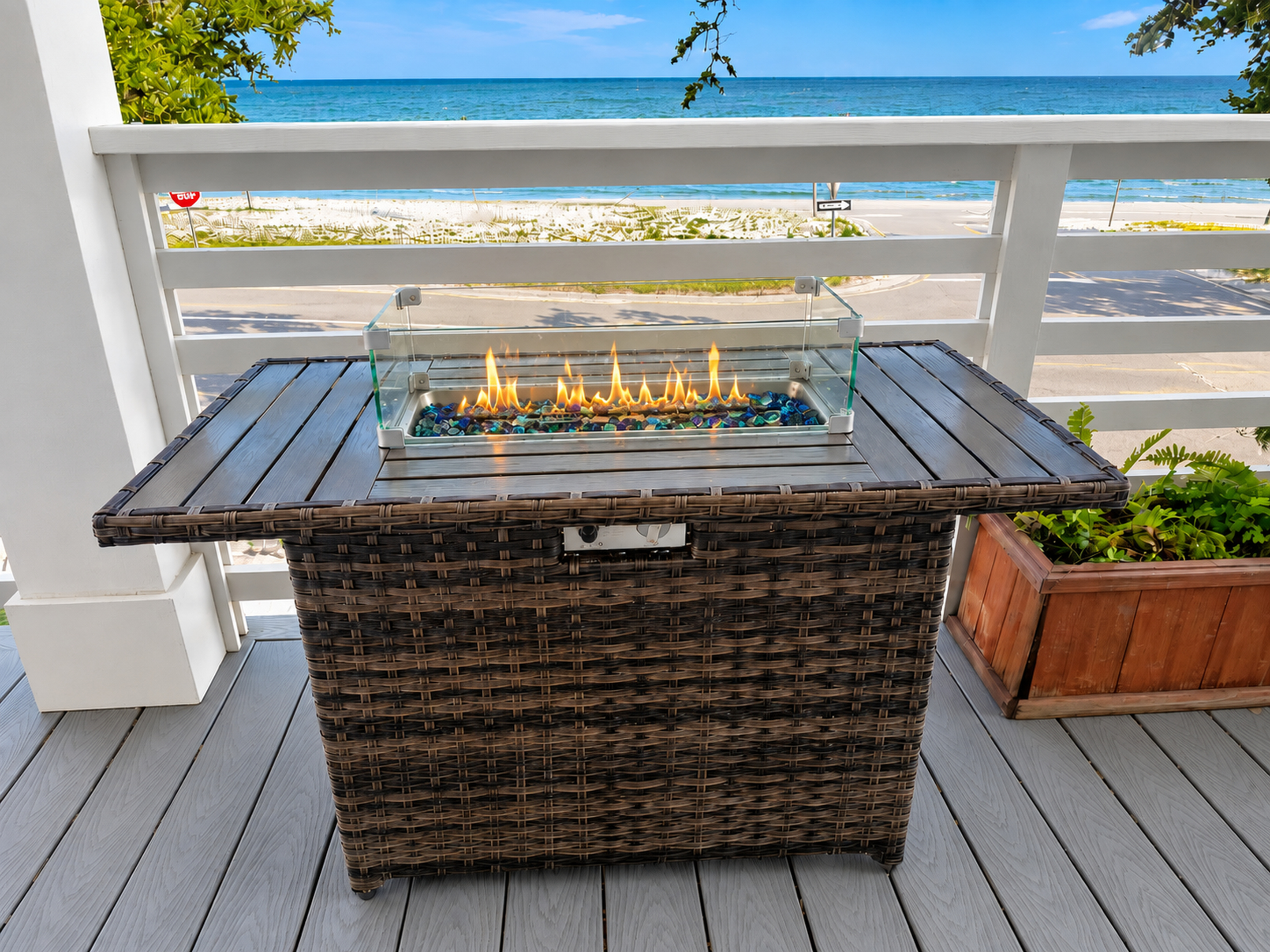 Ocean-view balcony with a cozy fire table and beachside ambiance