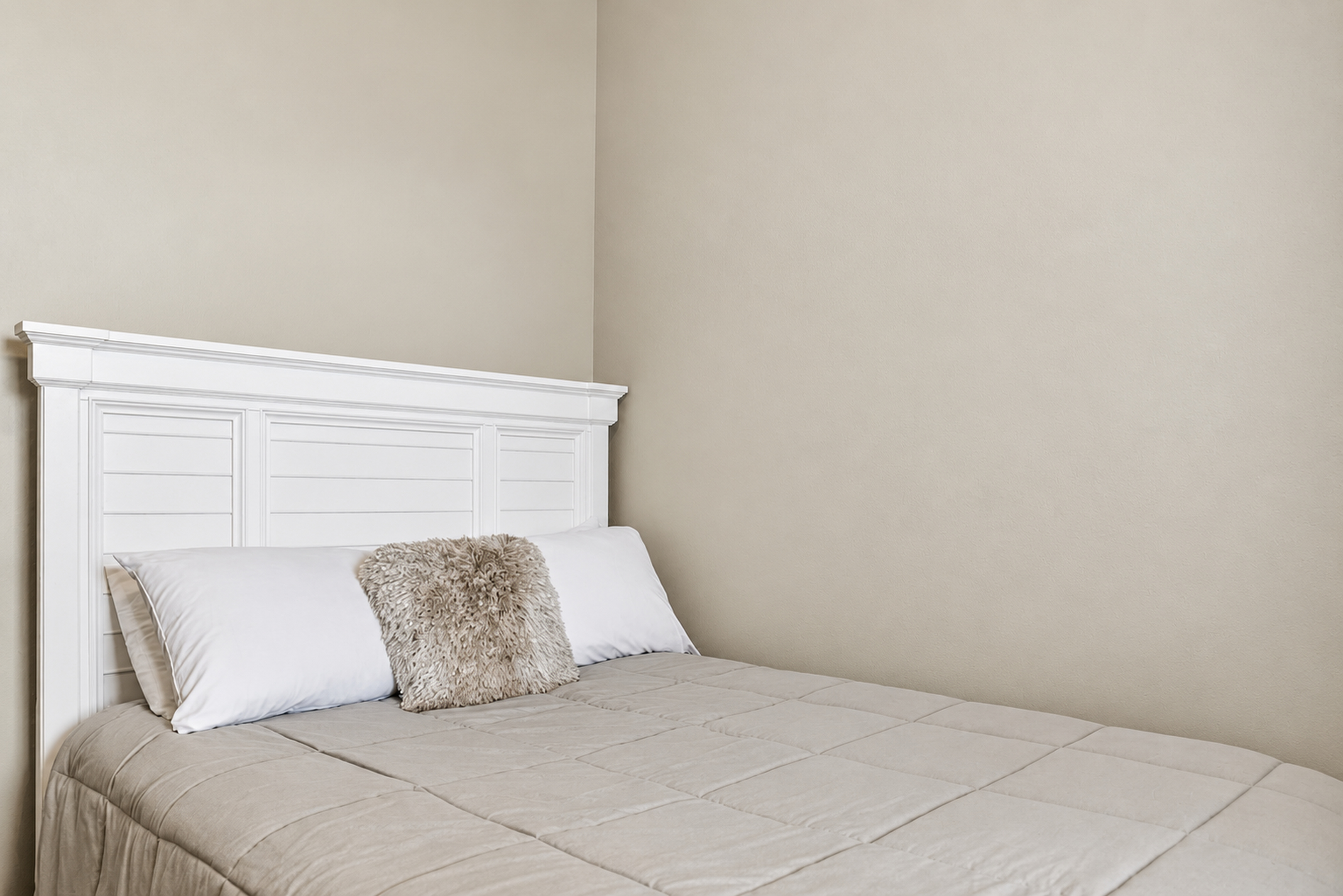 Cozy neutral bedroom with crisp white headboard and calming style
