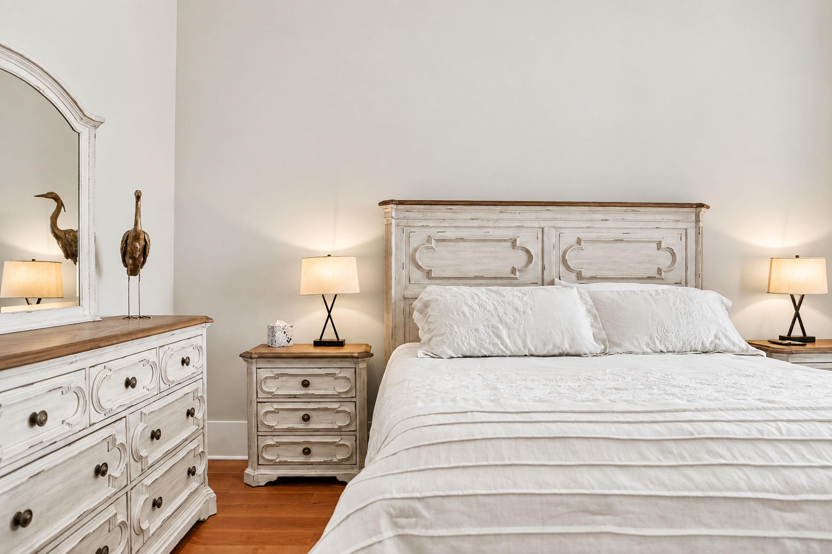 Bright, airy bedroom with elegant furnishings and plush white bedding