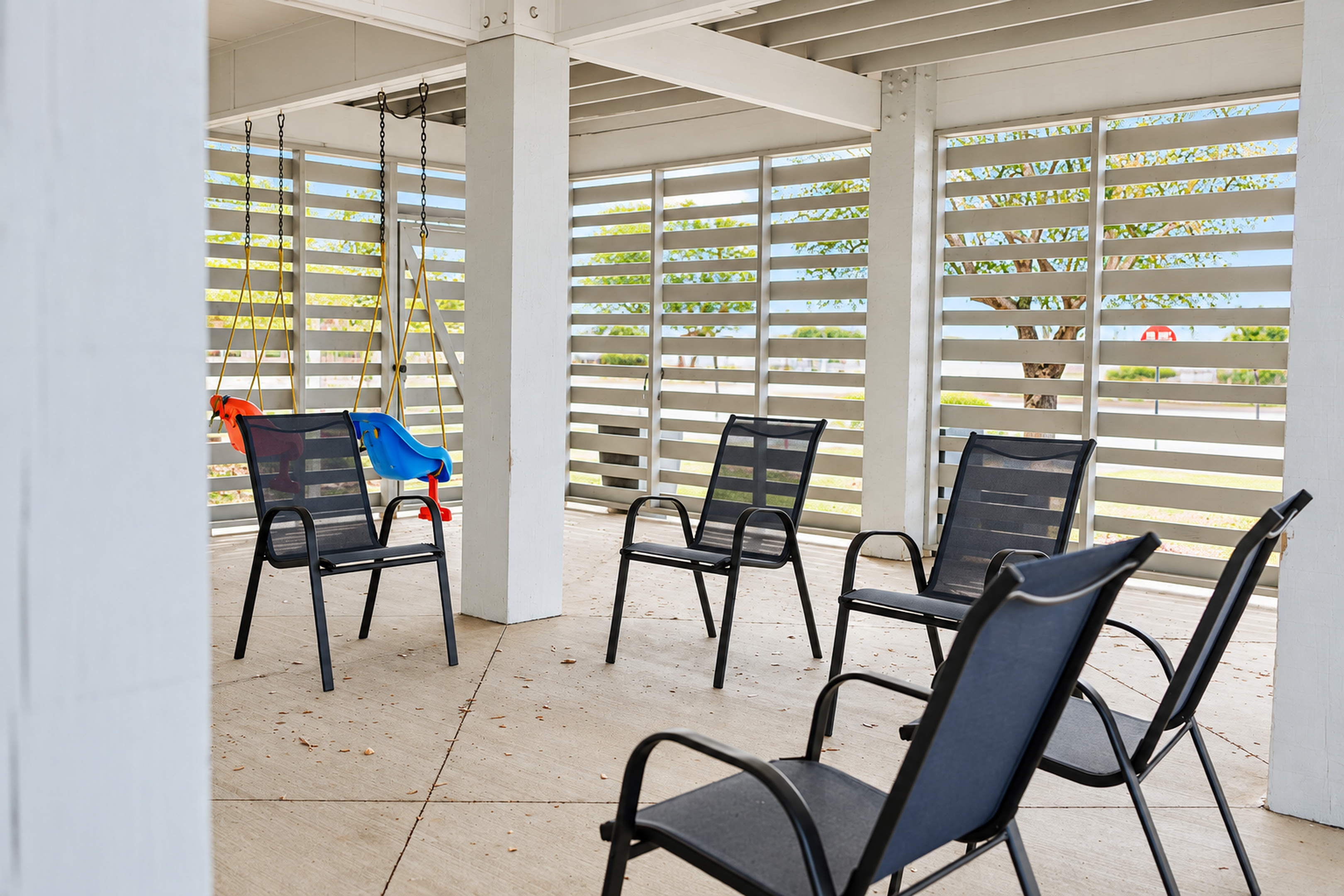 Shaded patio lounge with ample seating and a kid-friendly swing