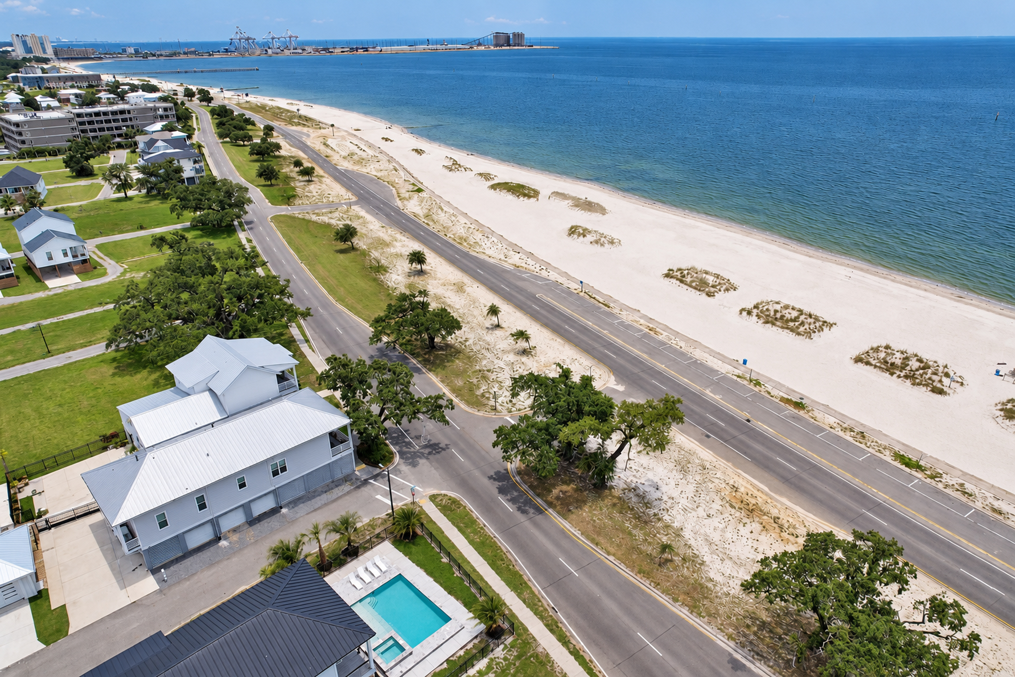 Aerial beachside retreat with private pool and sweeping coastal views
