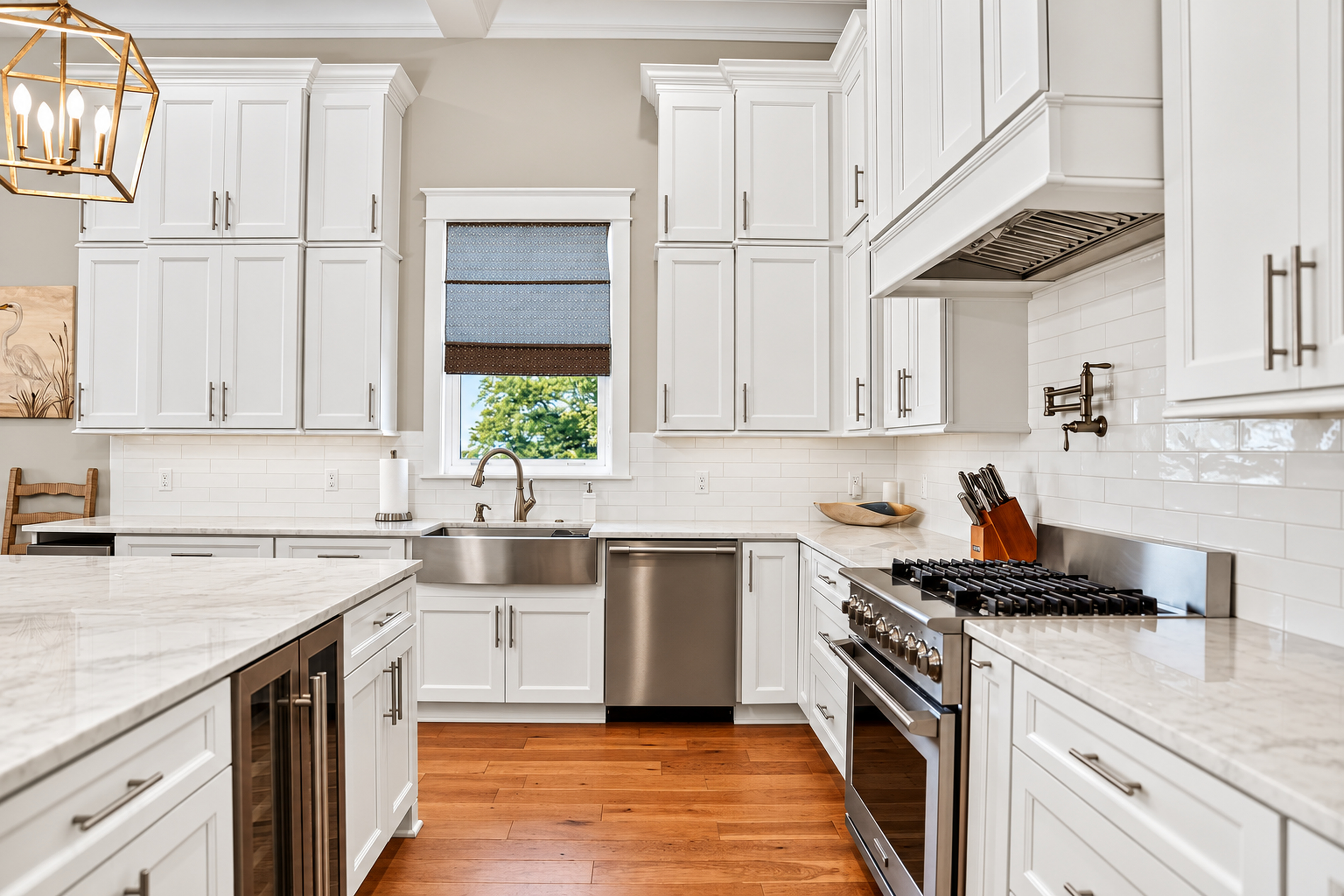 Bright gourmet kitchen with gas range, large island, and elegant finishes