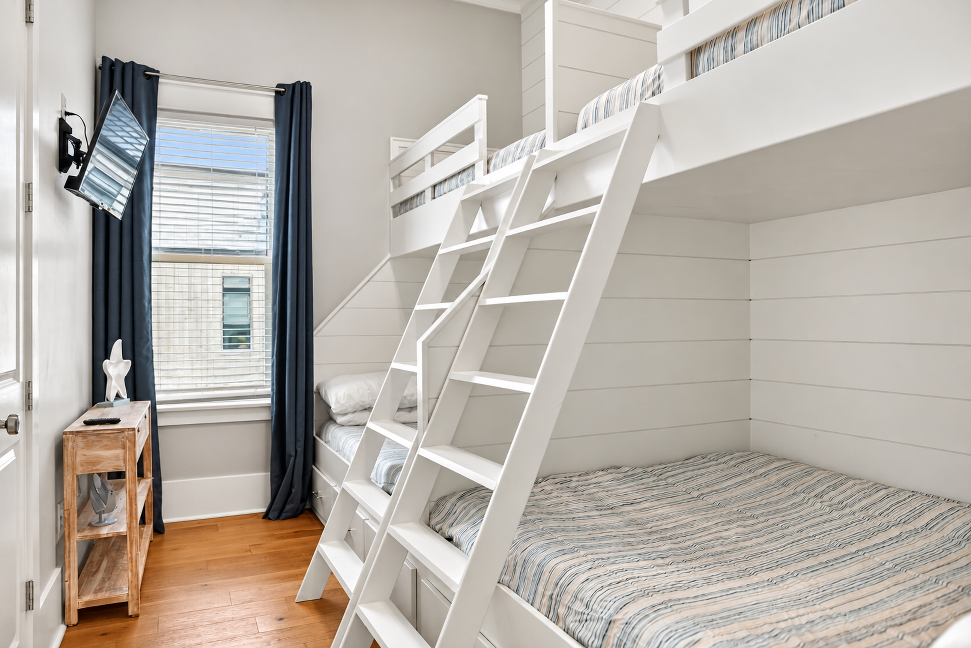 Bright custom bunk room with TV—perfect for kids, groups, or family stays