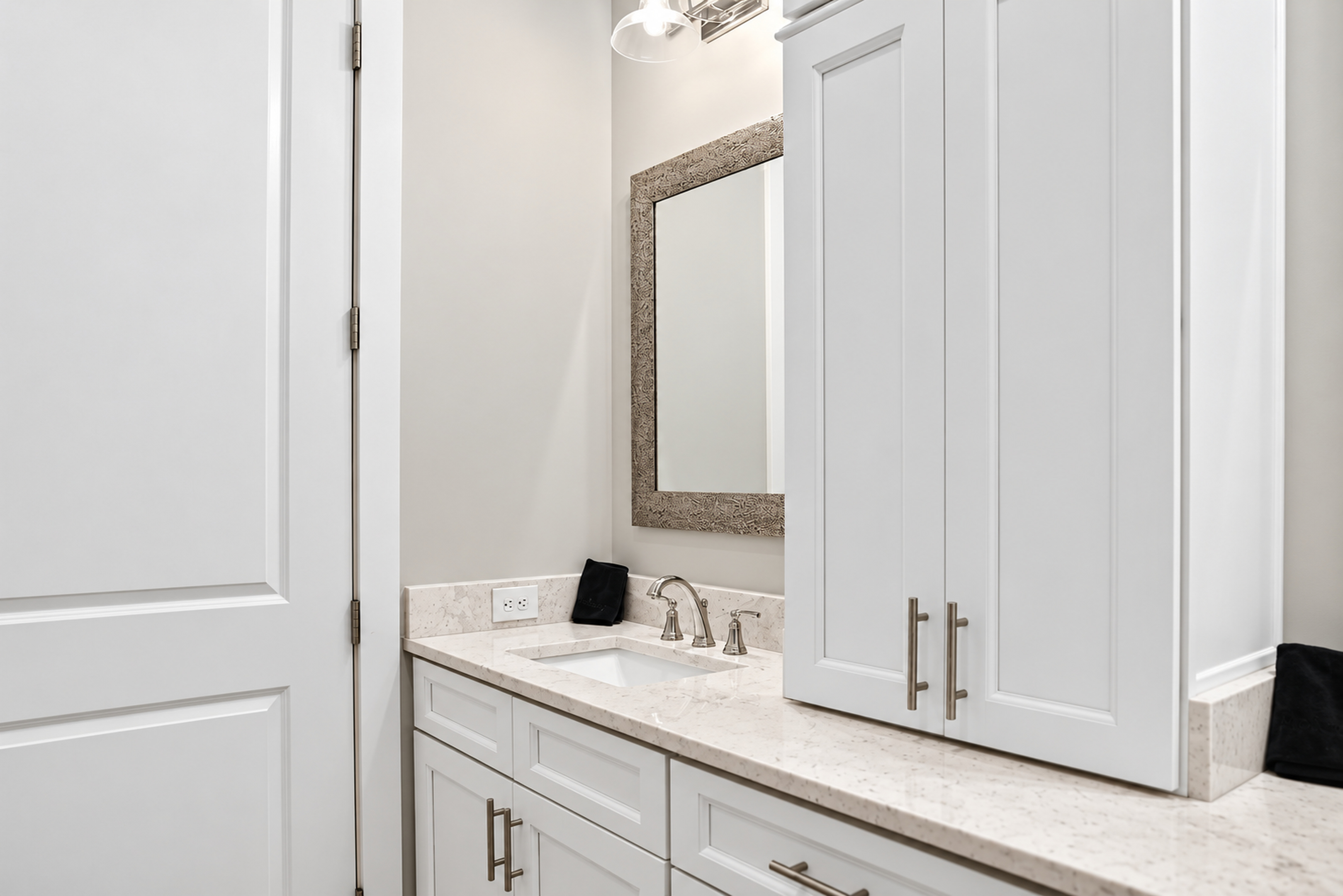 Bright modern bathroom vanity with stone counters and ample storage