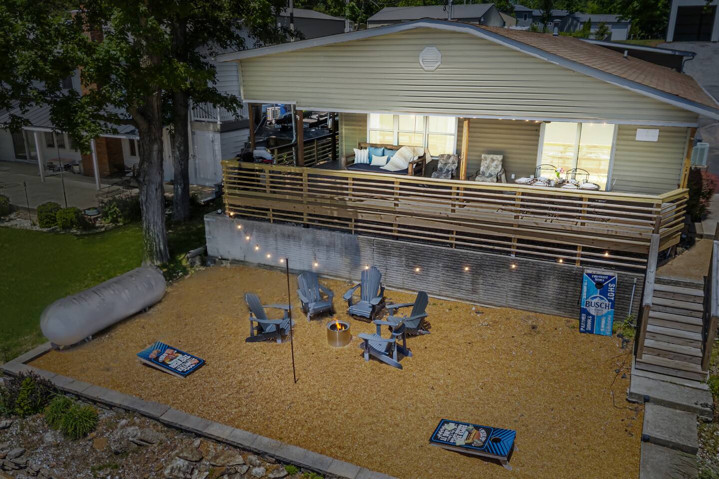 Private lakefront beach area with fire pit and Adirondack chairs
