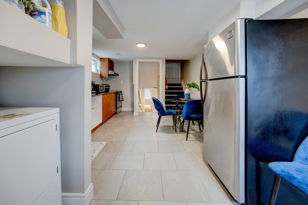 Sleek kitchen with stainless fridge, dine-in nook & in-unit laundry
