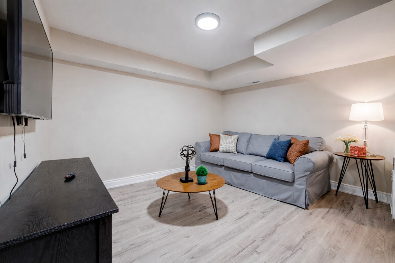 Cozy lounge with smart TV, comfy sofa & chic decor—perfect unwind.