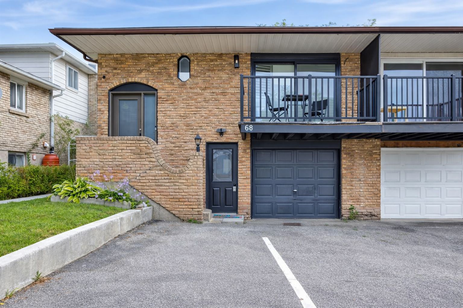 Brick home with balcony seating, garage and easy off-street parking.