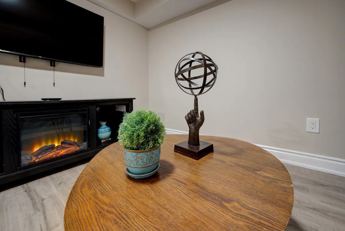 Warm media corner with electric fireplace and chic decor accents