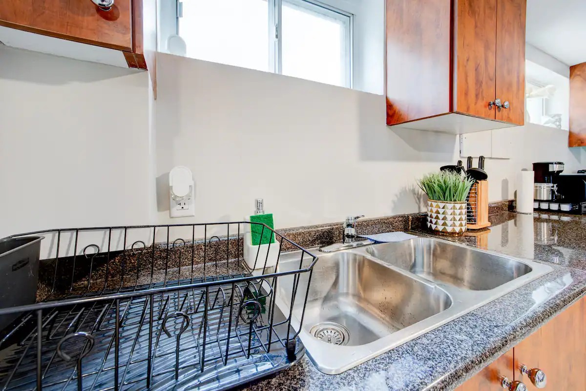 Bright kitchen with granite counters, double sink, and coffee setup