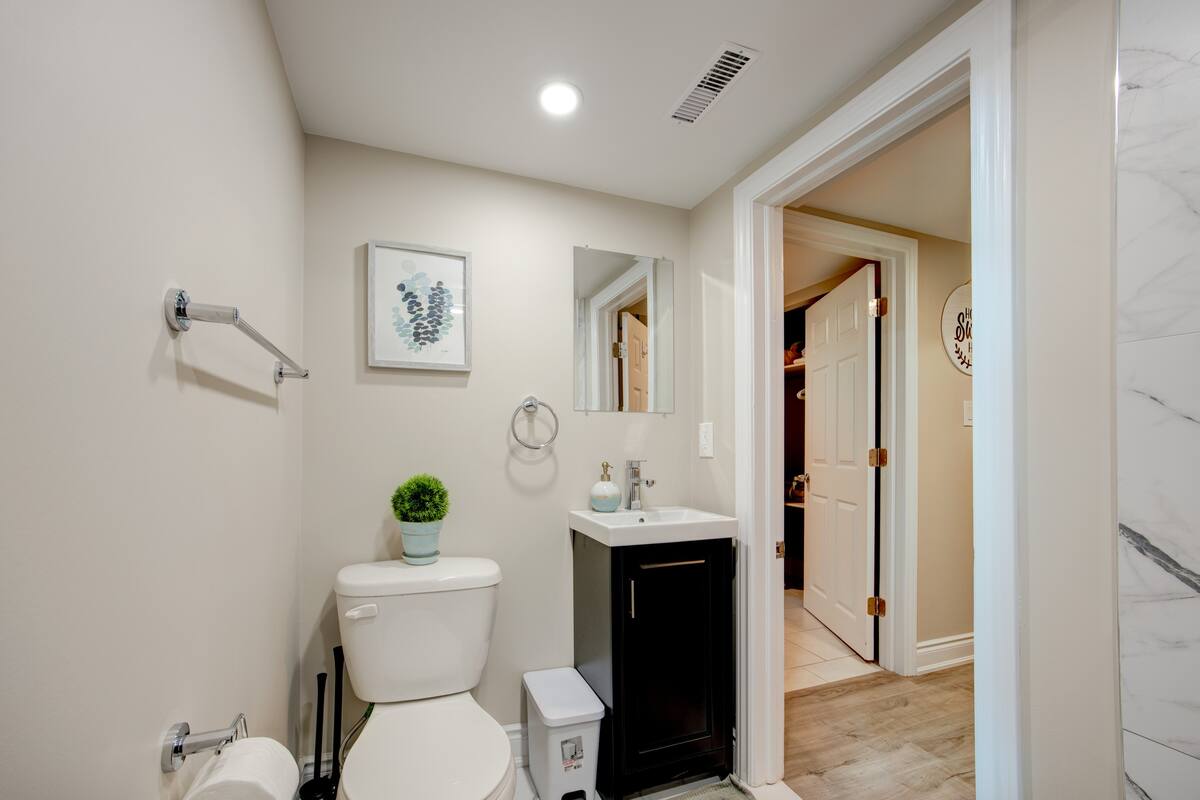 Modern, spotless bath with marble-tile shower and sleek vanity