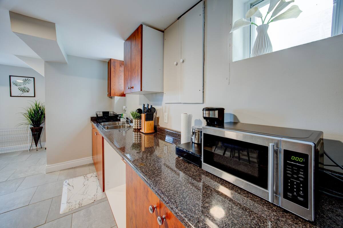 Sleek kitchenette with granite counters, microwave & coffee setup