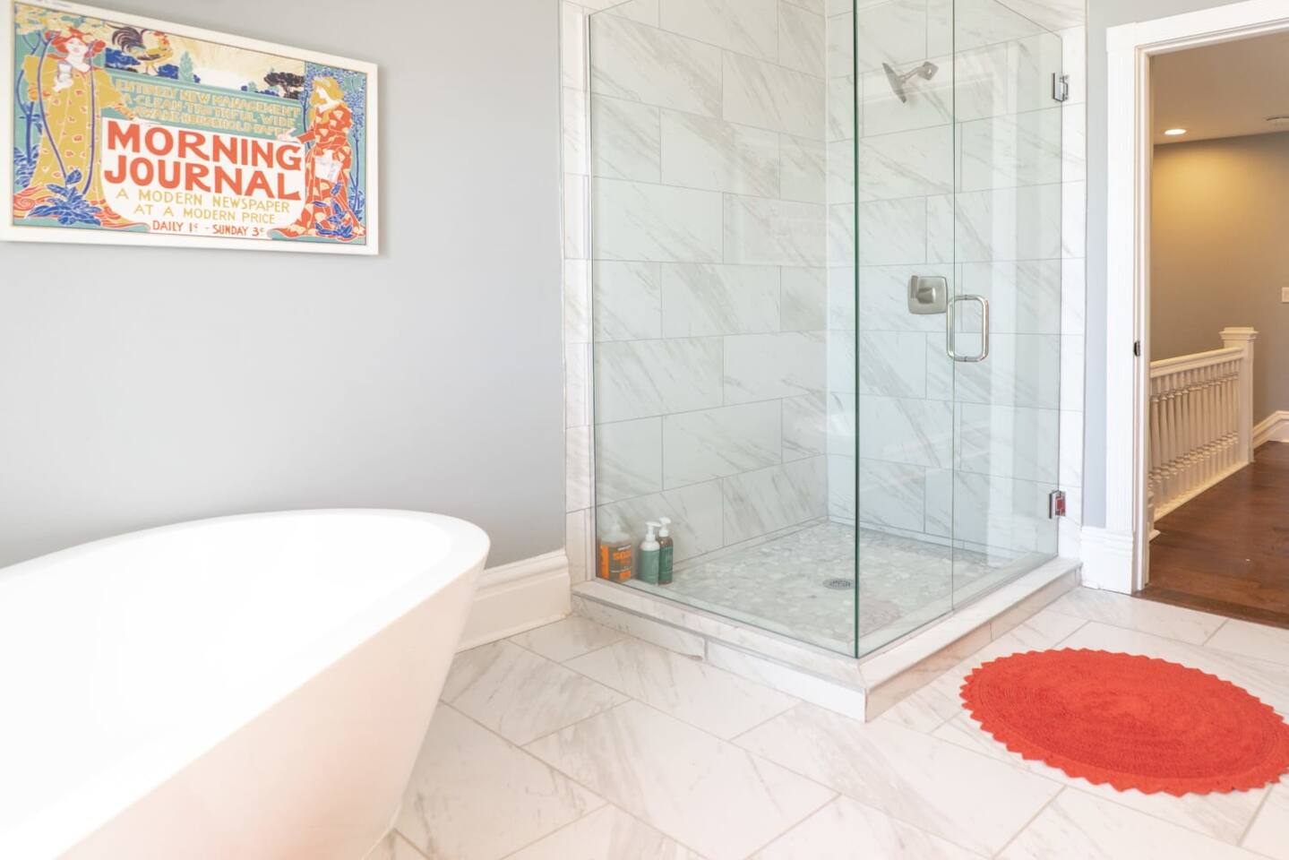 Standing shower complete with floor-to-ceiling tiling and waterfall showerhead