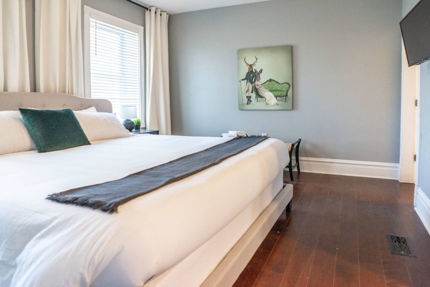 The large bed and wall-mounted TV make this a perfect end-of-day escape