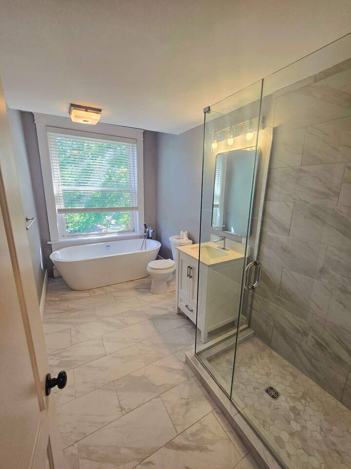 Relax in this spa-style bathroom with a soaking tub, walk-in shower, and plenty of natural light. Clean, modern, and peaceful.