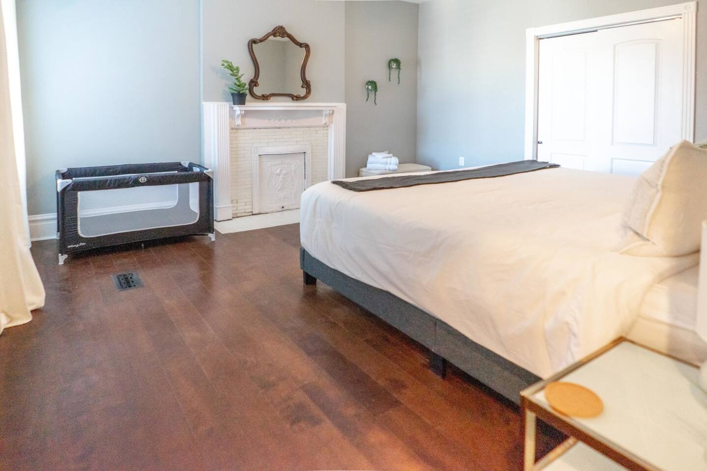 Bedroom two with a king bed and a Pack n’ Play cot for the little one