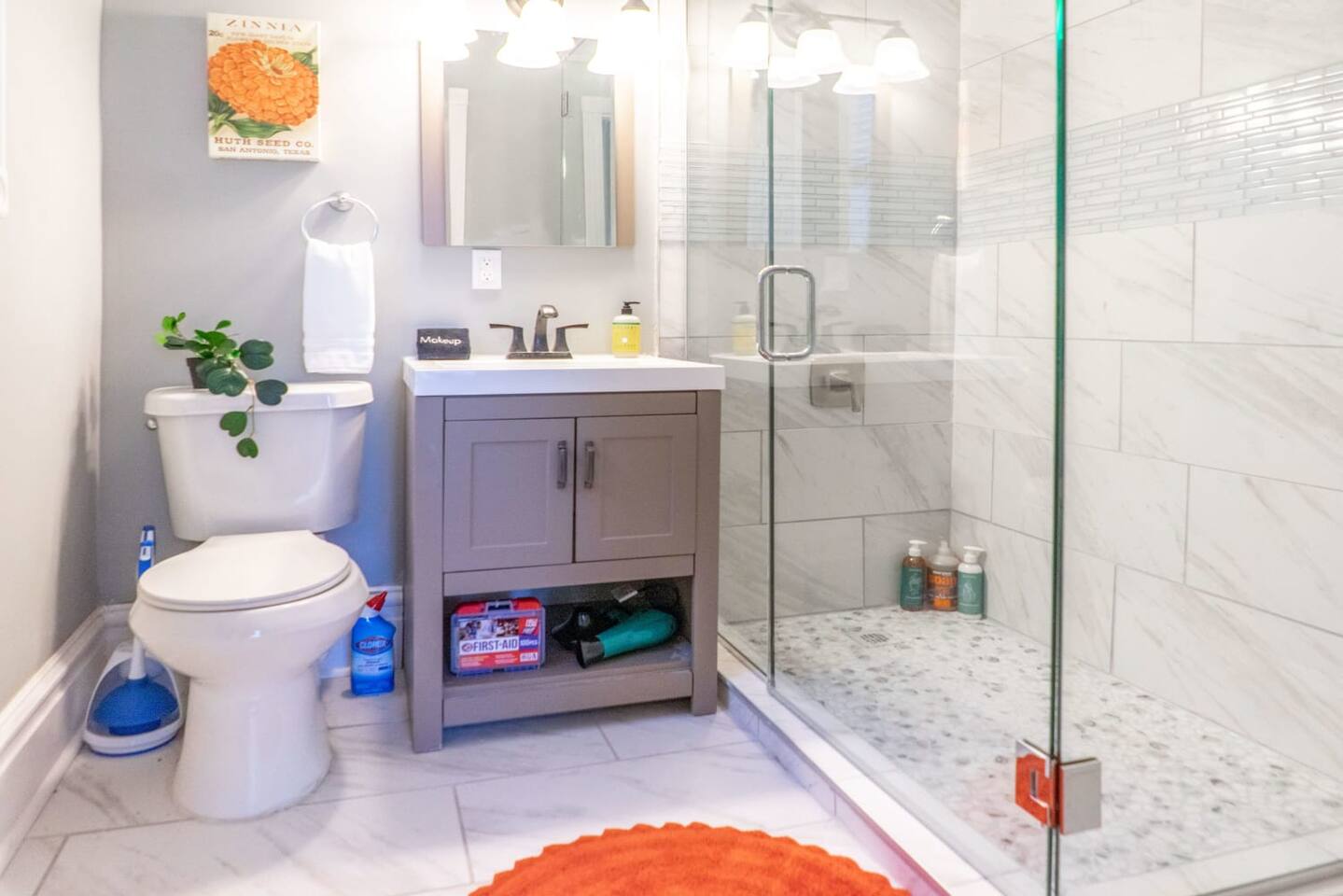 The sparkling second bathroom with a large walk in shower and a fully stocked vanity