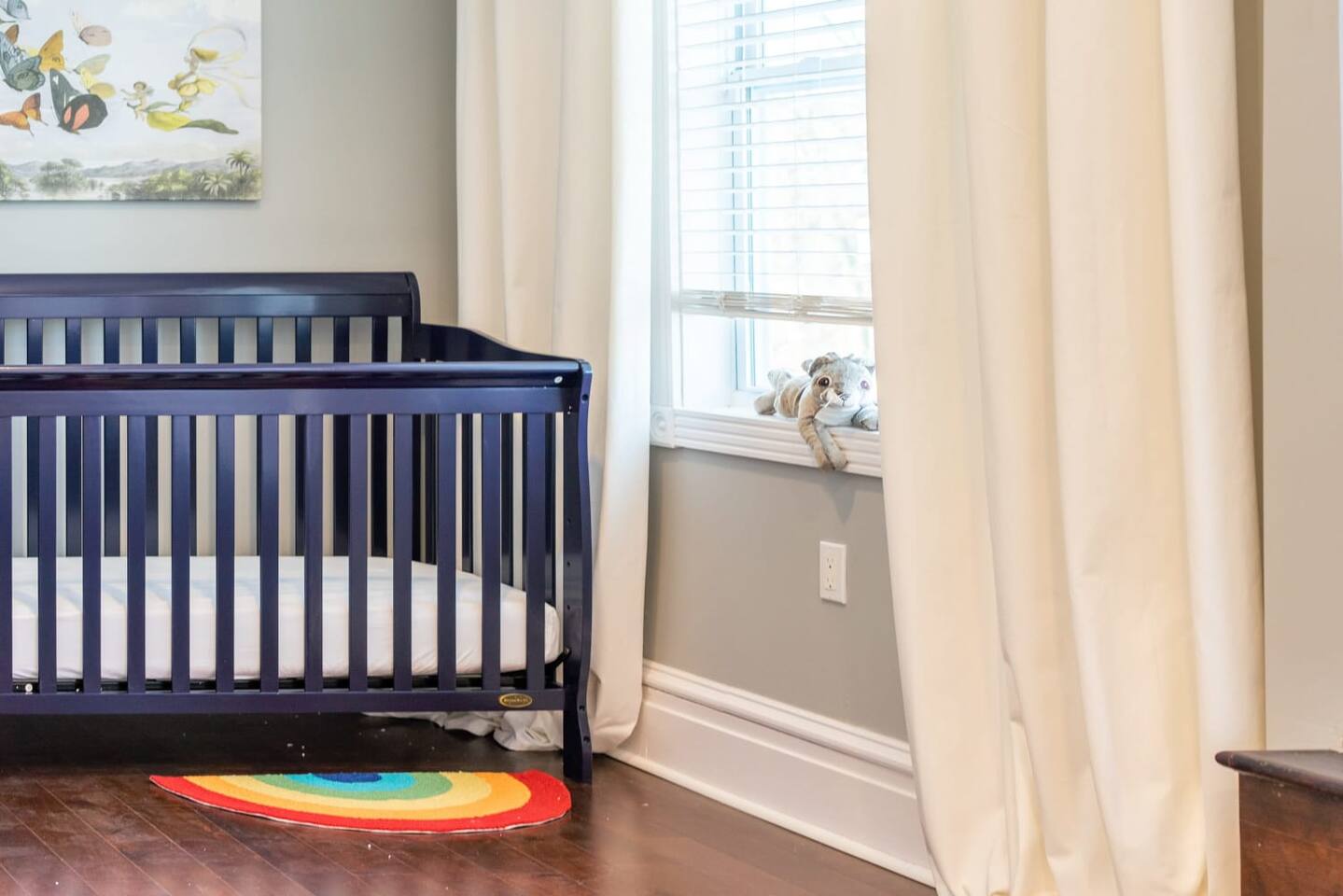 The beautiful crib by the window with a little friend to keep bub company at night