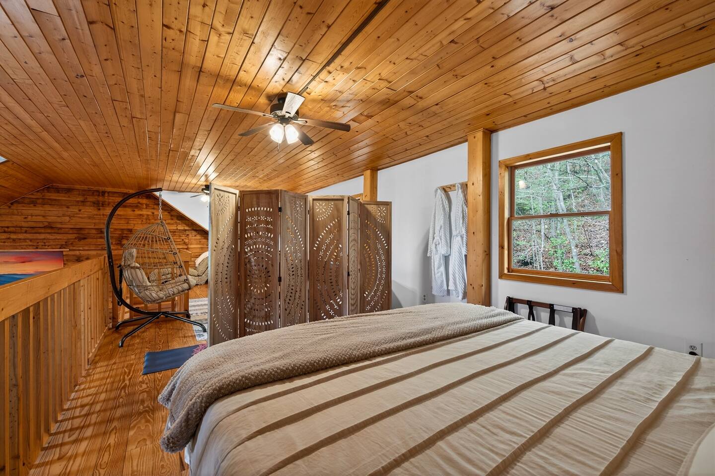 King size bed in the loft with a room divider ensures privacy when sleeping.